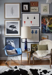 Eclectic living room interior styled by Marcus Hay featuring a gallery wall, blue rocking chair, and vintage armchairs