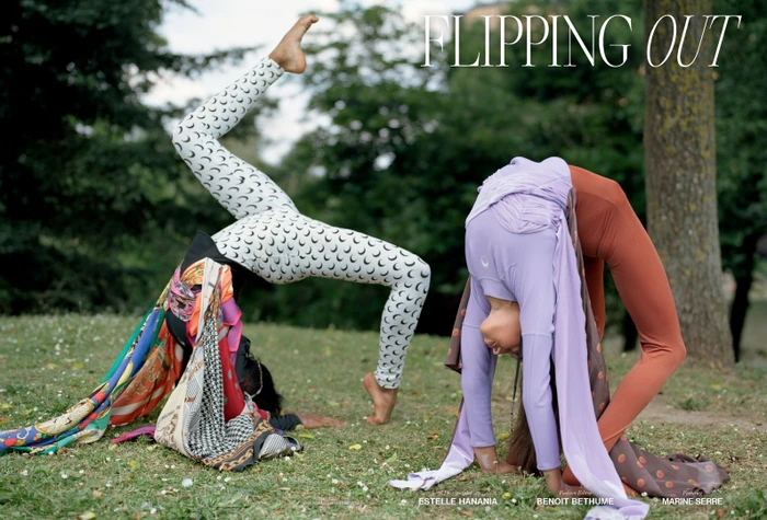 Two acrobatic models in patterned leggings and athletic wear bending backward into backbends on a grassy park lawn.