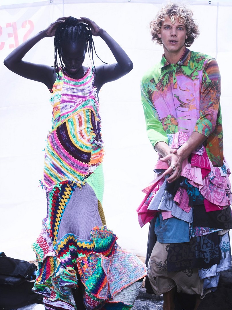 Two fashion models pose in distinctive patchwork clothing against a bright background, showcasing texture, pattern, and avant-garde style.