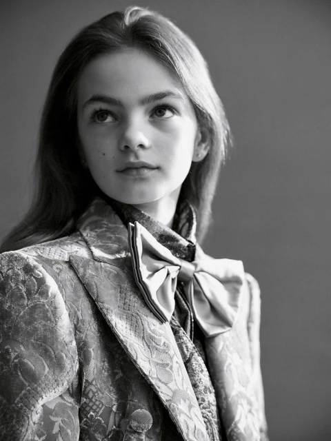 Portrait of young girl in patterned blazer and bow tie, styled by hair stylist Rory Rice in Sydney.