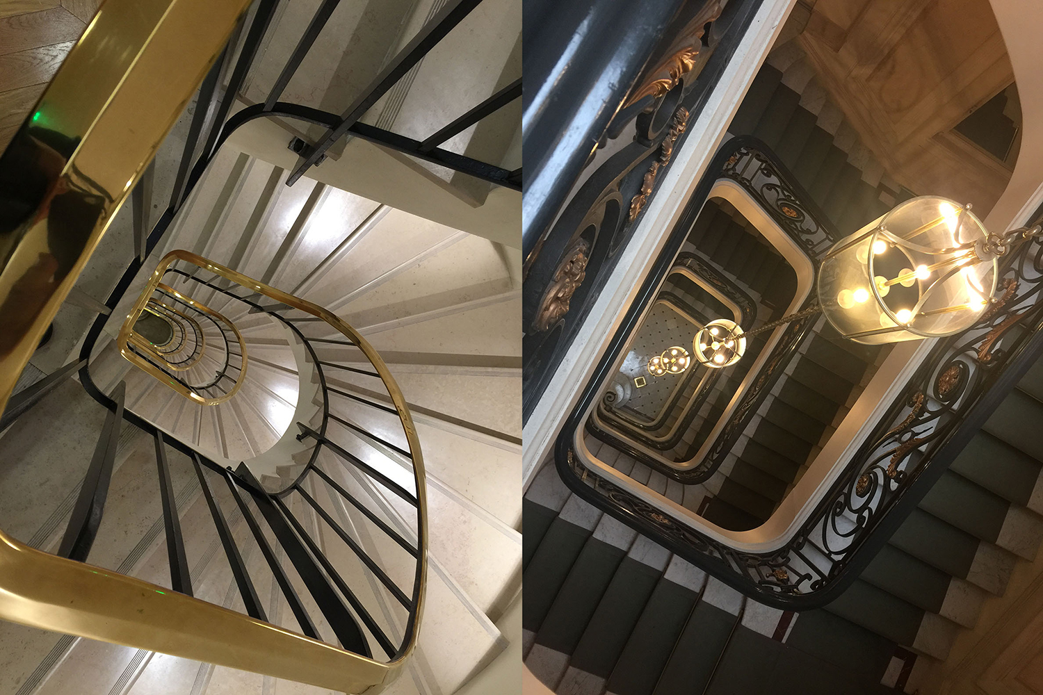 High-angle view of two grand staircases: one spiral with gold accents and white steps, the other with dark steps and ornate railings.