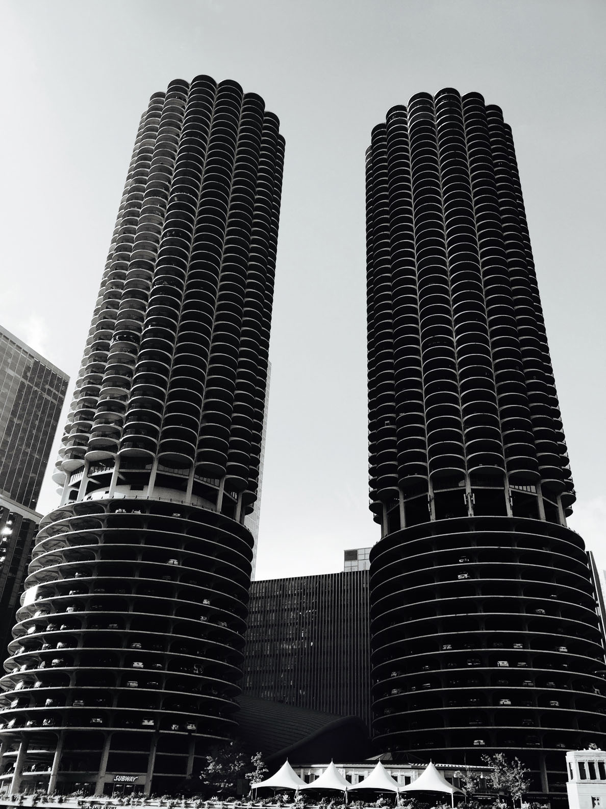 Monochrome photo of the Marina City towers in Chicago, Illinois, with their distinctive cylindrical forms and surrounding urban landscape.
