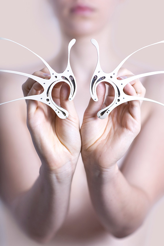 Close-up of a woman holding two white dental flossers; a beauty and personal care image for dental hygiene product marketing.