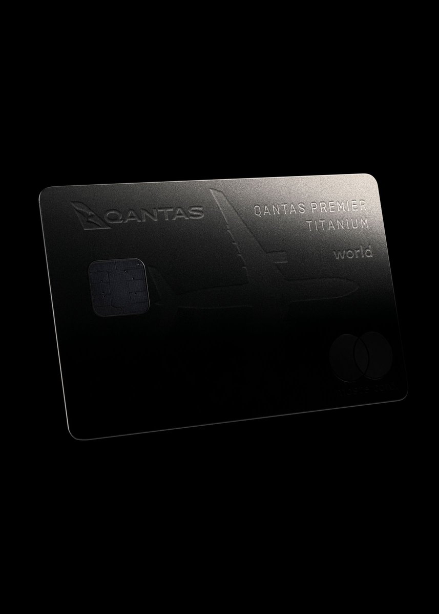 Titanium credit card with the Qantas logo and the word 'world' against a black backdrop, indicating a financial and travel-related product.