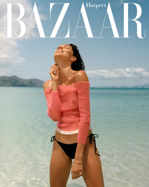 Fashion cover featuring a smiling woman in a pink sweater and bikini bottoms on a sunny beach, with 'Bazaar' masthead above.