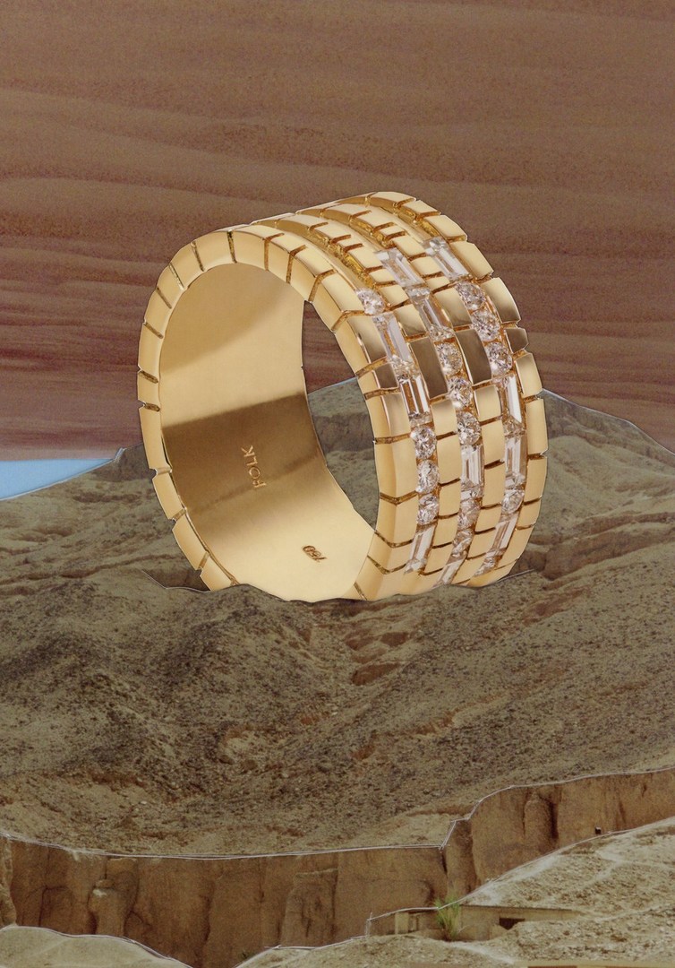 Gold ring with diamonds showcased against an illustrated desert landscape. Jewelry photography for advertising and promotion.