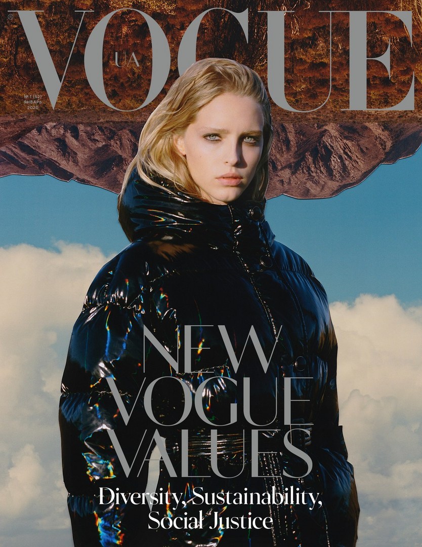 Vogue cover featuring a blonde adult female model wearing a black puffer jacket, photographed outdoors with mountains and blue sky in the background.