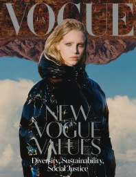 Vogue magazine cover featuring a blonde woman wearing a glossy black puffer jacket against a cloudy sky and mountainous background.