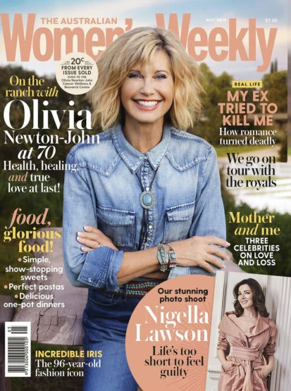 Magazine cover featuring Olivia Newton-John, focusing on her portrait, fashion details, and cover text against an outdoor backdrop.