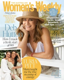 Magazine cover featuring woman wearing straw hat and white sleeveless top resting her chin on her hand