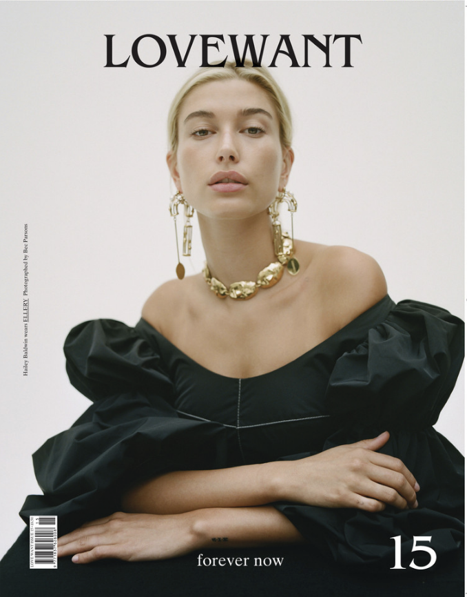 Hailey Bieber wearing an off-the-shoulder black puff-sleeve top and gold jewelry photographed by Bec Parsons