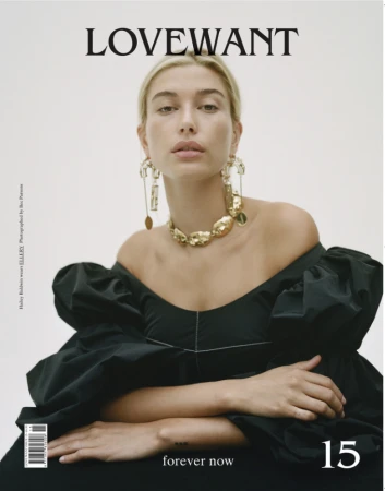 Hailey Bieber wearing an off-the-shoulder black puff-sleeve top and gold jewelry photographed by Bec Parsons