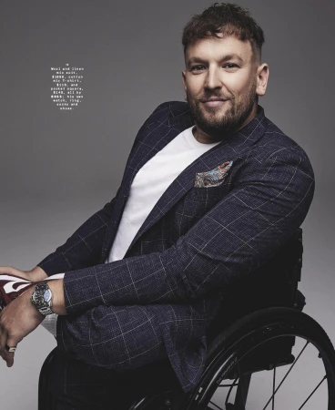 Man seated in a wheelchair wearing a navy windowpane check blazer and white t-shirt styled by Grant Pearce