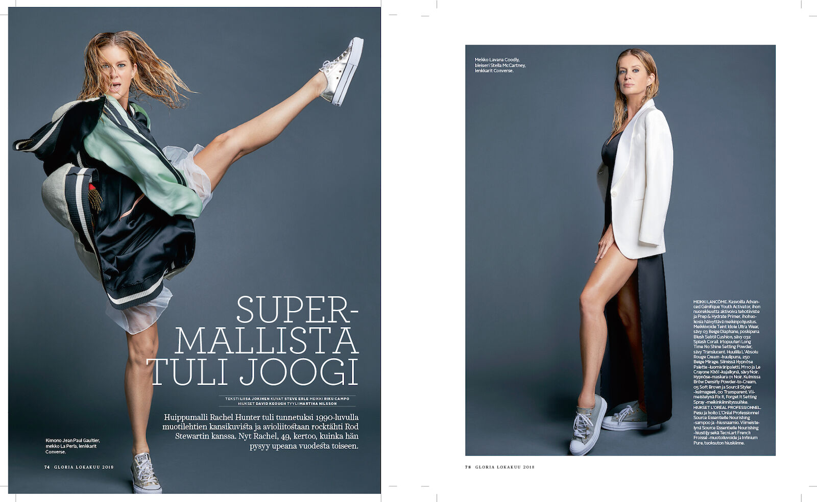 Fashion editorial photo of a woman in athletic jacket and sneakers, posed with leg raised on a gray background.