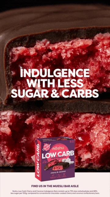 Close-up of a Noshu low-carb cherry and coconut bar, halved to show the texture, with text overlay and product packaging.