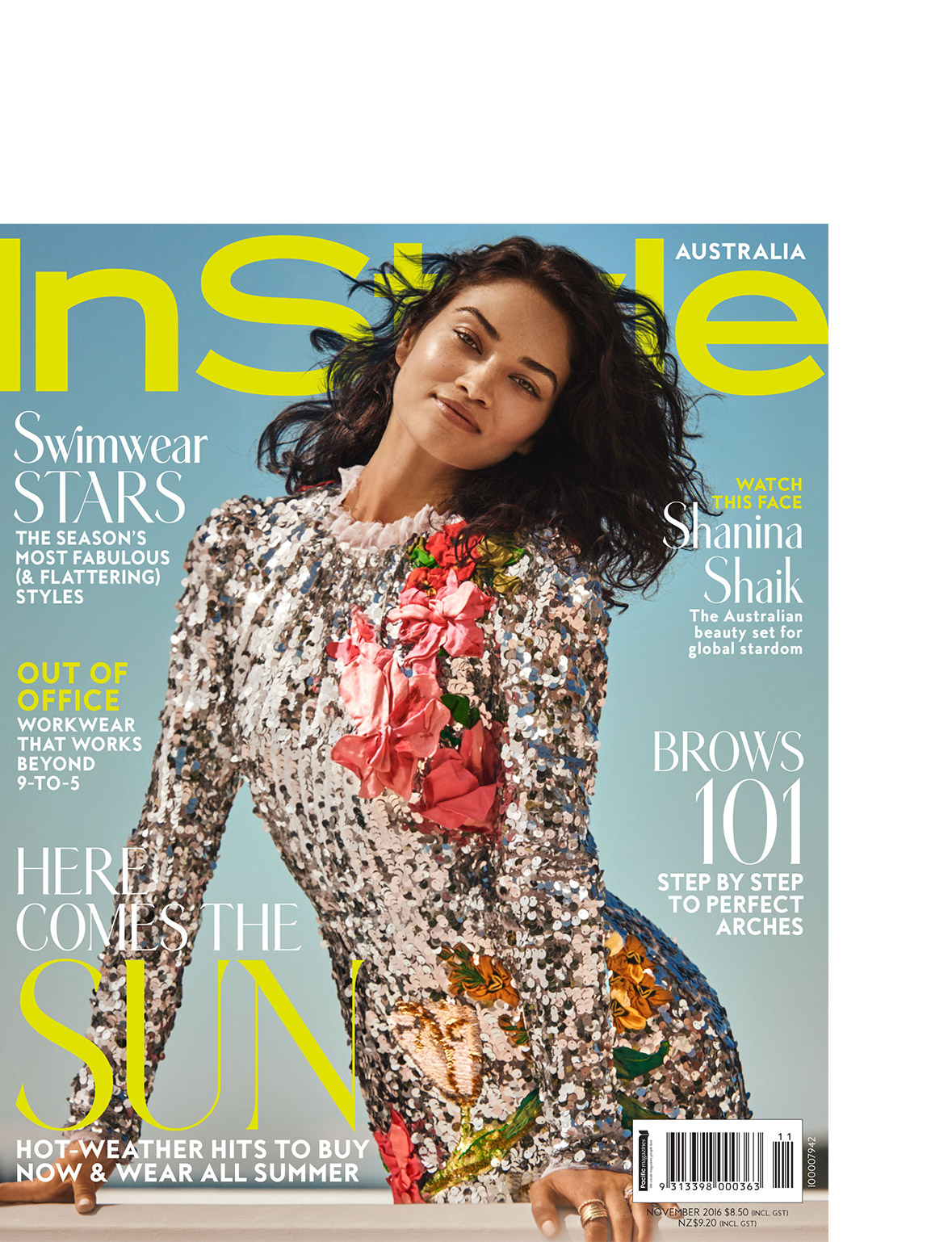 Magazine cover featuring Shanina Shaik in a sequined dress with floral accents against a light blue background with bold text.