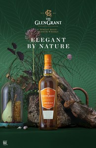 Glen Grant single malt scotch whisky bottle showcased with botanical elements and styled lighting in a product photography setting.