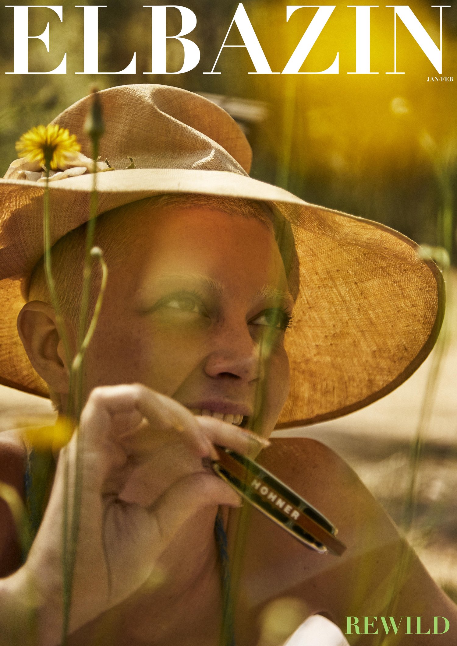 Woman with harmonica wearing a straw hat outdoors in a field, illuminated by sun, for Elbazim magazine summer issue.