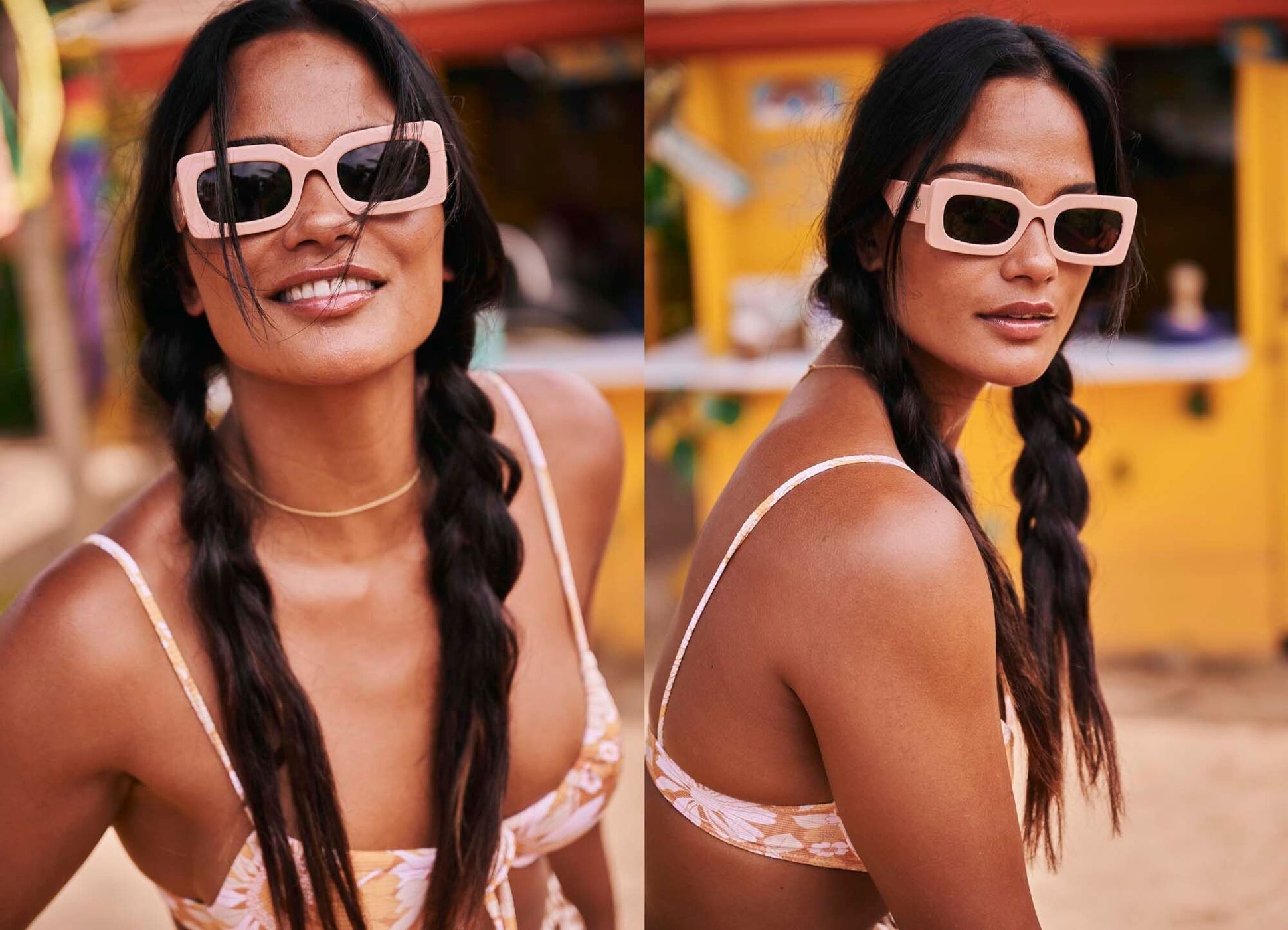 A woman in sunglasses and a floral print swimsuit poses outdoors. She has dark hair in braids and a gold necklace, smiling at the camera.