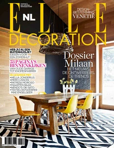 Elle Decoration magazine cover featuring an interior scene with a rustic wooden table, yellow chairs, and a black and white zigzag rug.