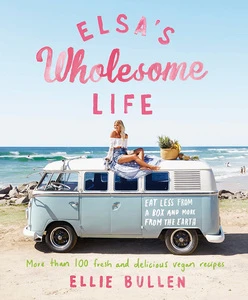 Book cover featuring a woman sitting on a blue van with a beach and ocean backdrop promoting 'Elsa's Wholesome Life' and vegan recipes.