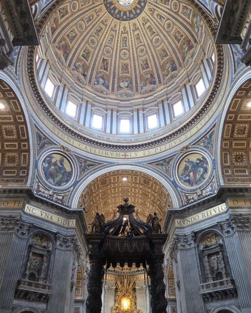 Intricate architecture of St. Peter's Basilica dome features paintings, windows, and ornate carvings, creating a visually stunning interior view.