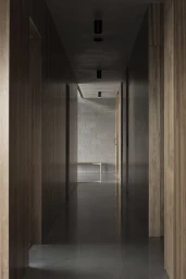Modern narrow hallway in Melbourne styled by Bek Sheppard with wooden panel walls and polished concrete floors.