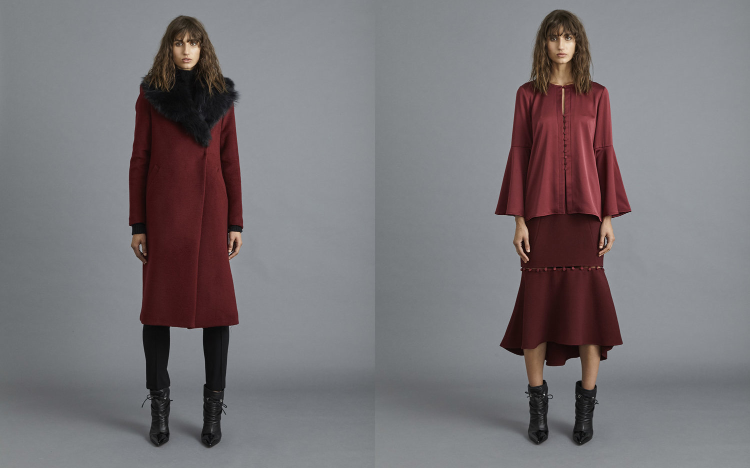 Two adult females wear fashionable burgundy overcoats and skirts in a studio with a gray background, complemented by black ankle boots.