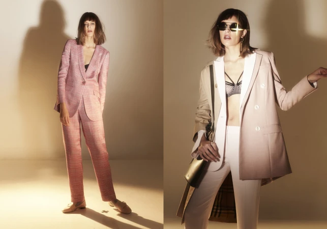 Two side-by-side fashion portraits of a woman wearing tailored suits and sunglasses against a lit studio wall.