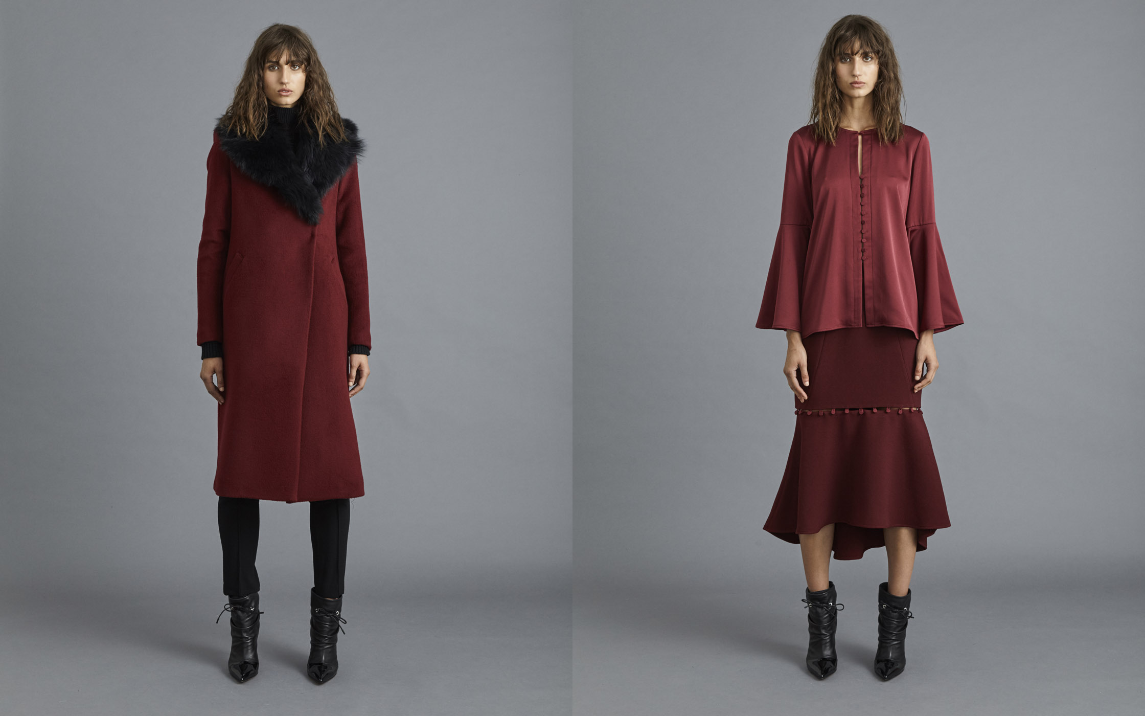 Two fashion models showcase deep red apparel, including a coat with a fur collar and a flared-sleeve blouse with a matching midi skirt.