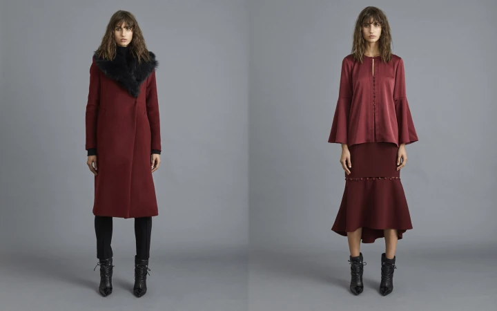 Two fashion models showcase deep red apparel, including a coat with a fur collar and a flared-sleeve blouse with a matching midi skirt.