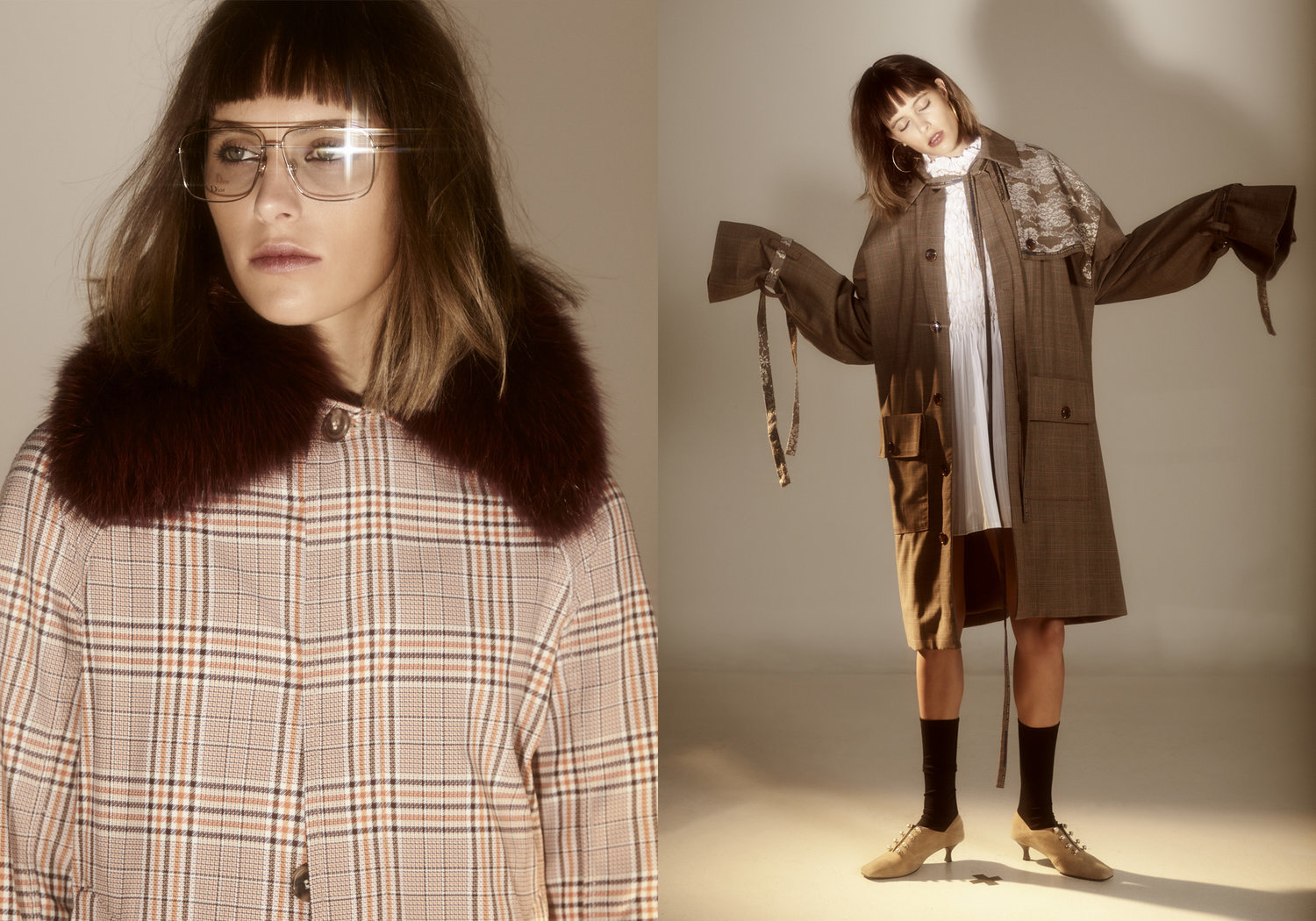 Two women in studio shot, one in a plaid coat with a fur collar and glasses, the other in a long brown coat with white dress.