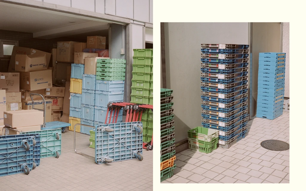 Stacked and nested plastic crates and cardboard boxes fill an indoor storage area with a tiled floor in a brightly lit, organized fashion.