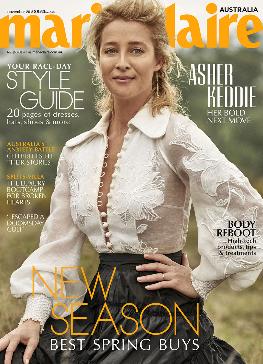 Magazine cover featuring Asher Keddie in a sheer floral top and tiered skirt, promoting spring fashion, against an outdoor backdrop.
