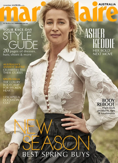 Magazine cover featuring Asher Keddie in a sheer floral top and tiered skirt, promoting spring fashion, against an outdoor backdrop.