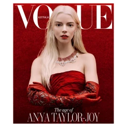 Anya Taylor-Joy wearing a red dress and red gloves with a diamond necklace against a red textured backdrop for Vogue Australia.