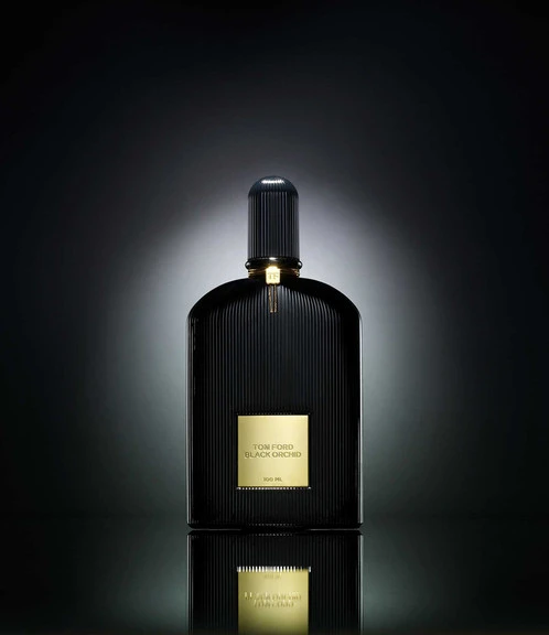 Black Tom Ford Black Orchid perfume bottle, gold label, studio lighting, dark background, luxury beauty and fragrances, elegant product shot.