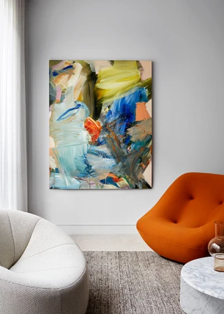 Abstract painting with bold strokes of blue yellow and orange hanging on a light grey wall in a modern living room interior