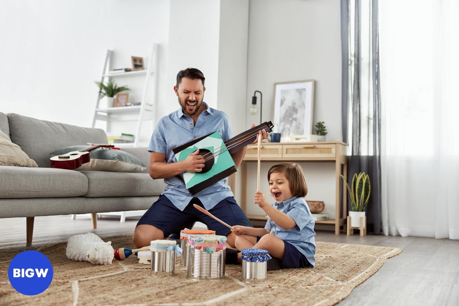 A father and child are indoors, playing musical instruments and making music together in a cheerful and fun-filled family activity.