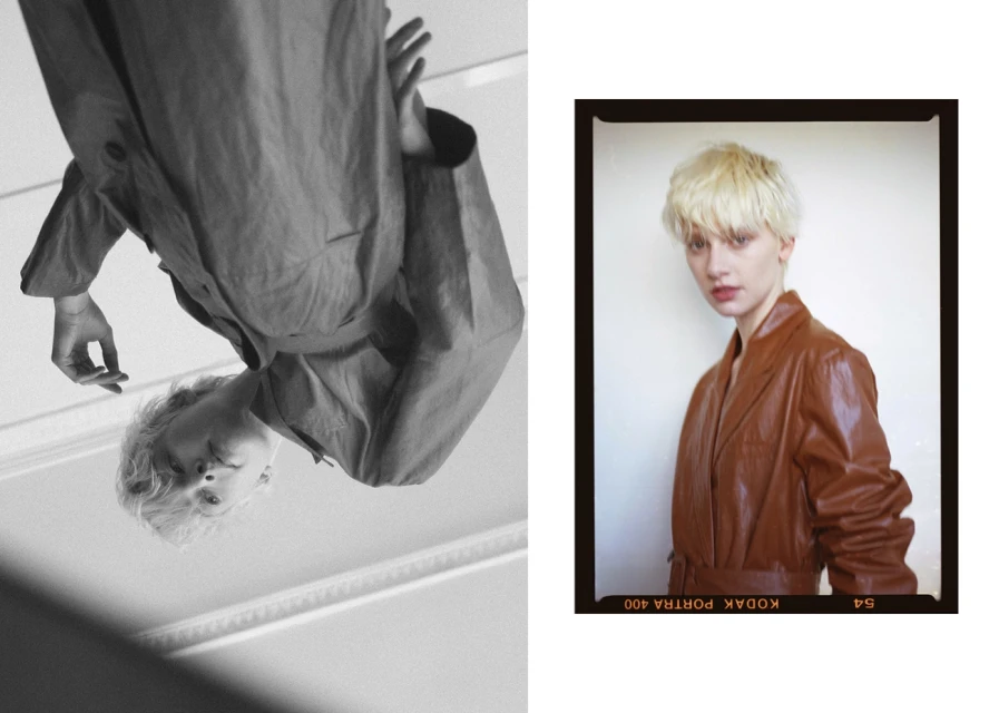 Two portraits of a blonde woman, one reflected upside-down in black and white, the other in color wearing a brown coat against a white wall.