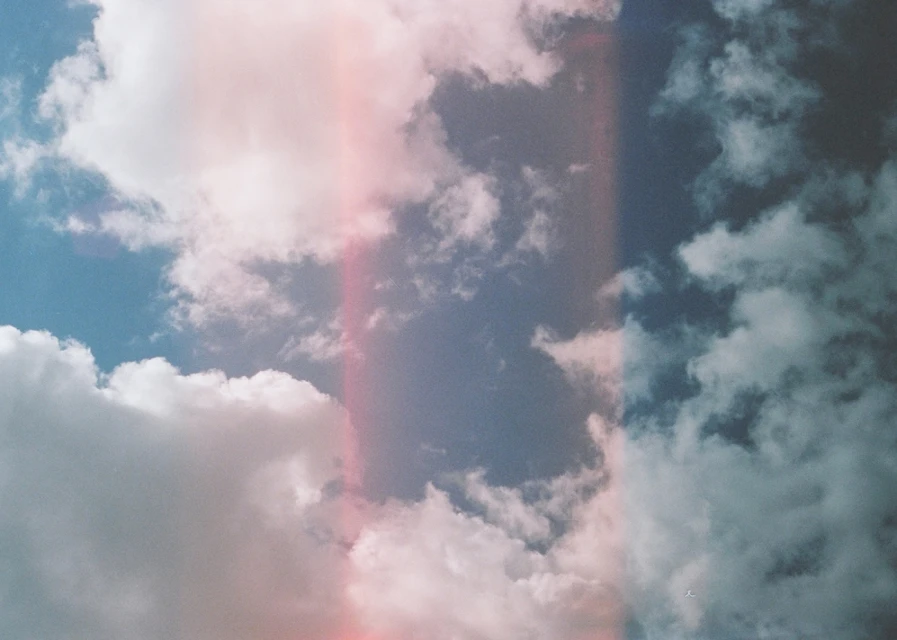 Sky filled with fluffy white clouds against a blue backdrop, creating a serene and airy atmosphere, possibly in daylight.