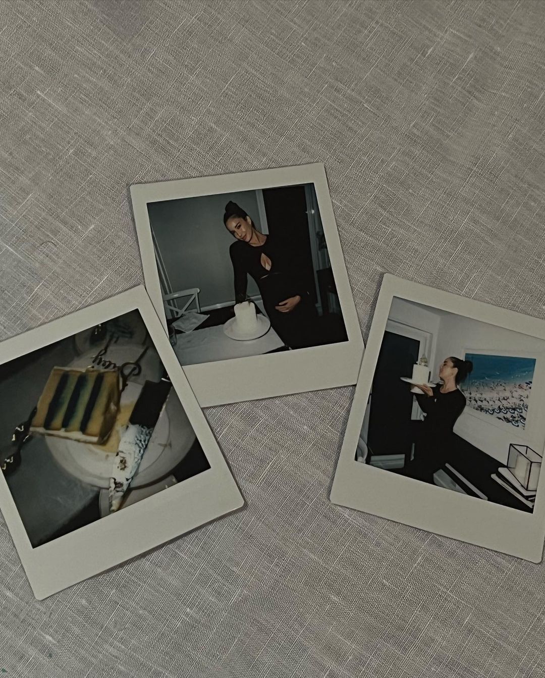 Three Polaroid prints show a pregnant woman and cake, on a linen tablecloth, capturing a celebratory, intimate moment in a neutral setting.