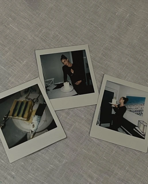 Three Polaroid prints show a pregnant woman and cake, on a linen tablecloth, capturing a celebratory, intimate moment in a neutral setting.