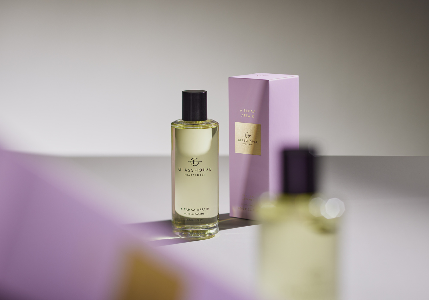 Glasshouse Fragrances 'A Tahaa Affair' perfume bottle and matching box with clean studio lighting and soft pastel colors.