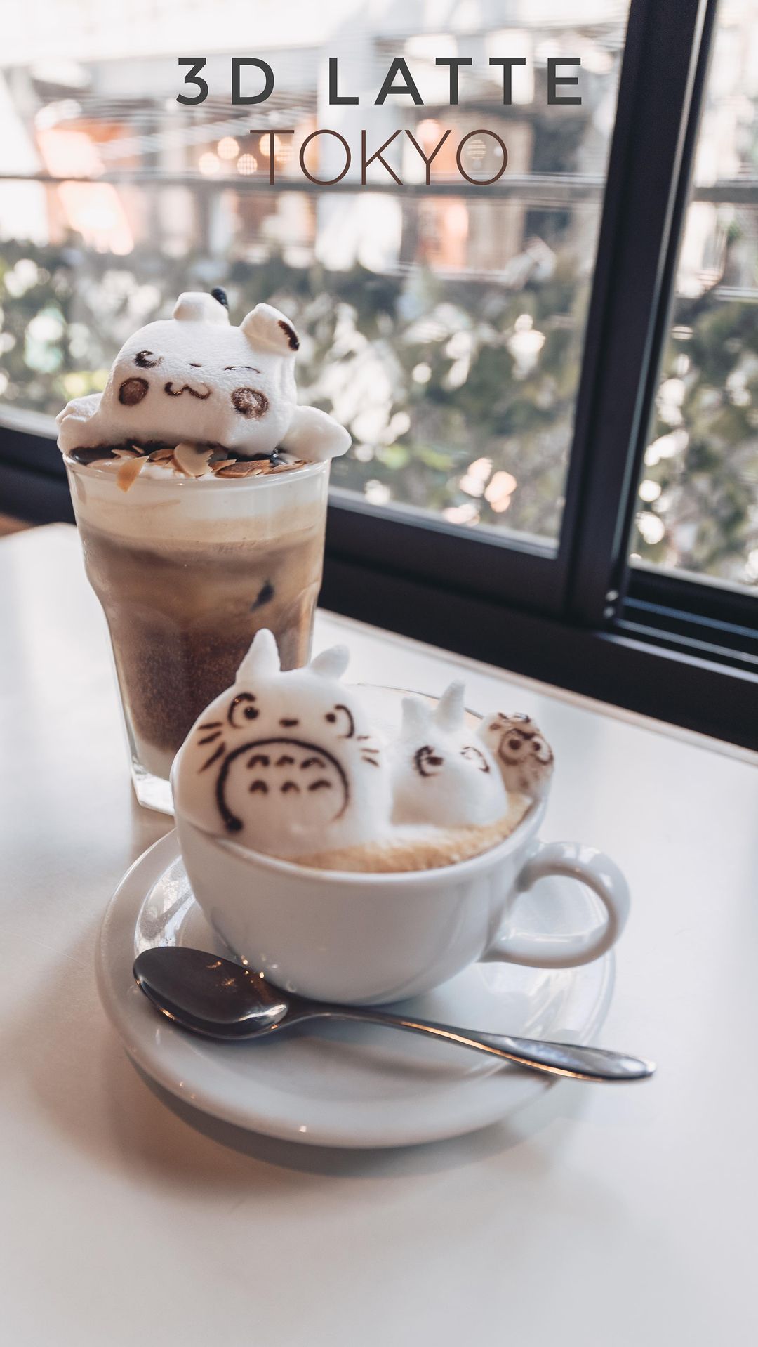 3D latte art featuring cute cartoon characters on coffee drinks in a bright cafe setting, Tokyo, Japan, near a window.