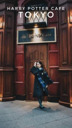 A woman in a Hogwarts school uniform and dark robe stands before the dark wood entrance of the Harry Potter Cafe in Tokyo.