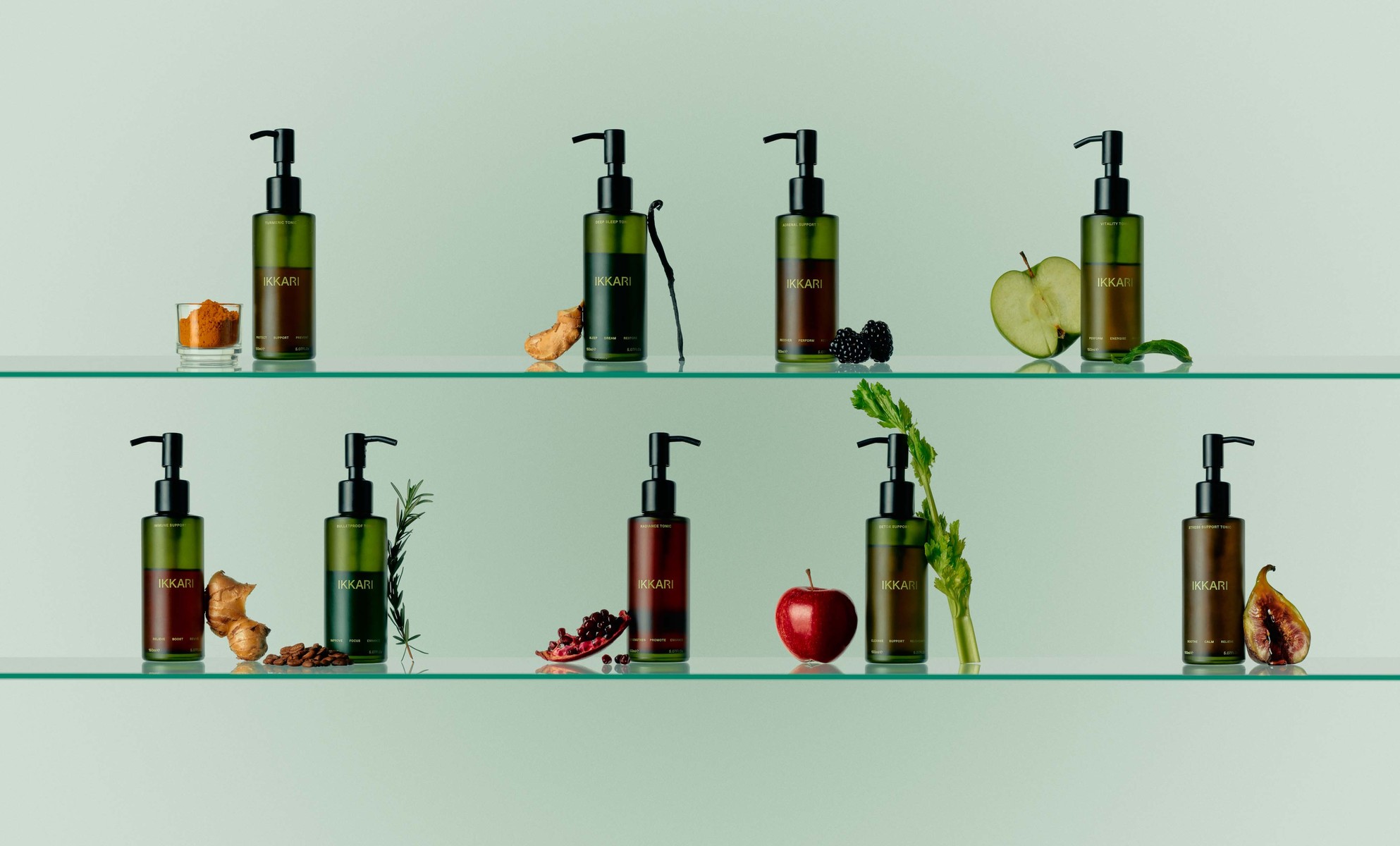 Bottles of Ikari product displayed on glass shelves with fruit, vegetables, and spices against a soft green gradient background.