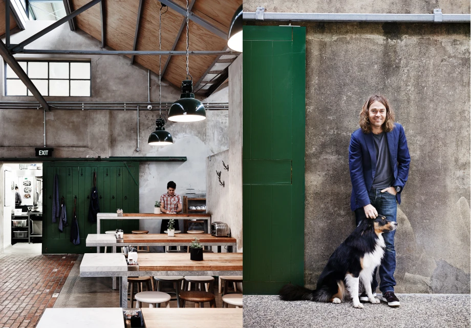 Industrial cafe interior and exterior featuring a man petting a dog, with neutral color palette, wooden furniture, and green accents.