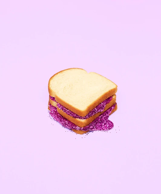 Three slices of white bread stacked with glitter on a light purple background in a visually striking composition for design use.