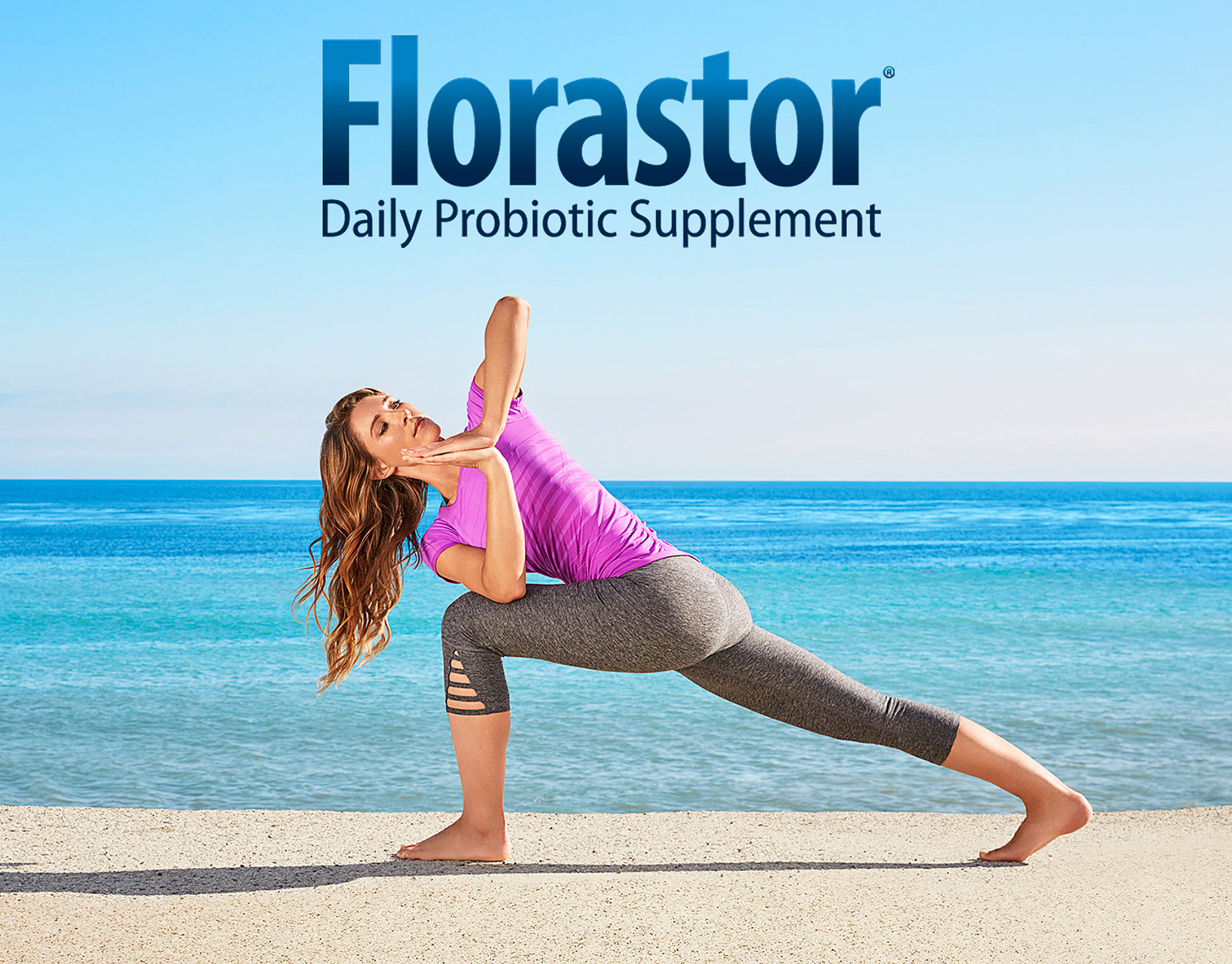 A woman in fitness wear practices yoga on a beach with blue sky and ocean backdrop, promoting Florastor Daily Probiotic Supplement.